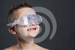 Smiling little boy in swimming mask. wet kid