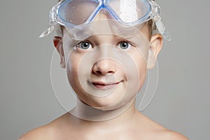 Smiling little boy in swimming mask. wet kid