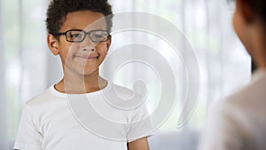 Smiling little boy wearing glasses, happy with good eyesight, ophthalmology