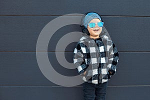 Smiling little boy 2-3 years old enjoying his favorite music in headphones