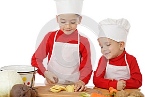 Smiling little chief-cookers on the desk