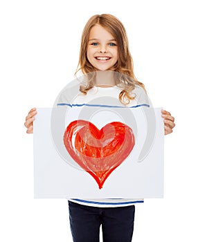 Smiling little child holding picture of heart