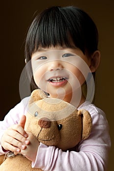 Smiling little child with a teddy bear