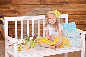 Smiling little girl and alive chickens on bench