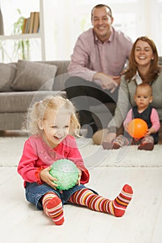 Smiling little girl with ball