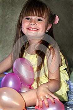 Smiling Little Girl with Balloons