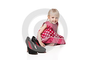 Smiling little girl with big shoes