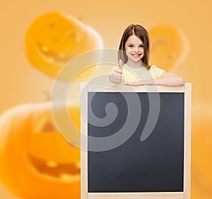 Smiling little girl with blackboard