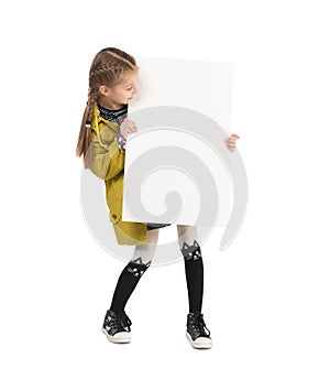 Smiling little girl with blank sheet in hands