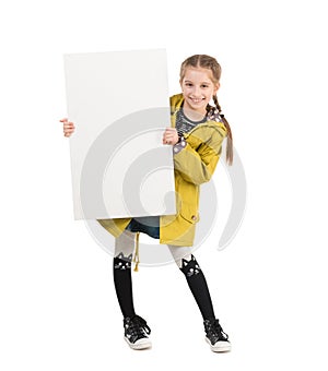 Smiling little girl with blank sheet in hands