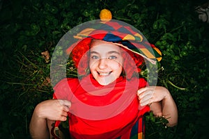 Smiling little girl in clown wig