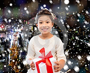 Smiling little girl with gift box