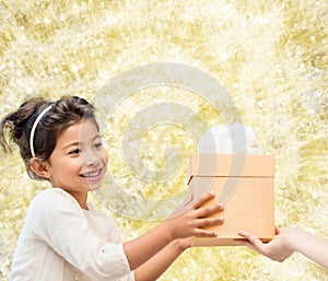 Smiling little girl with gift box