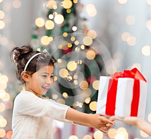 Smiling little girl with gift box