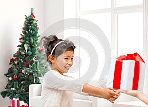 Smiling little girl with gift box