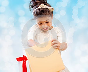 Smiling little girl with gift box