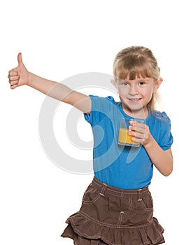 Smiling little girl with a glass of orange juice