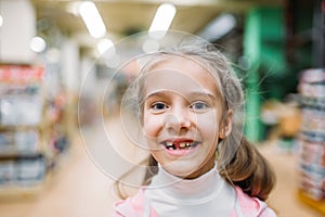 Smiling little girl, happiness in pet shop