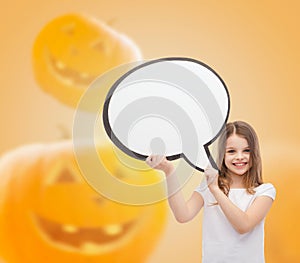 Smiling little girl holding big white text bubble