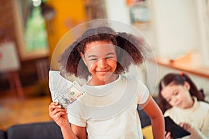 Smiling little girl holding a pile of banknotes photo