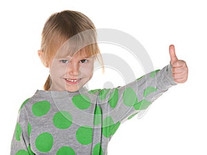 Smiling little girl holds thumb up