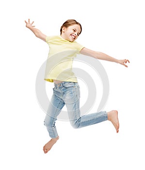 Smiling little girl jumping