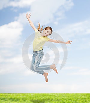 Smiling little girl jumping