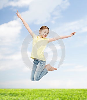 Smiling little girl jumping