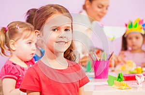 Smiling little girl in kindergarten classroom