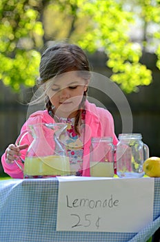 Smiling little girl at lemonade stand in summer