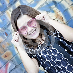 Smiling little girl with pink glasses