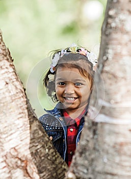 A smiling little girl is playing in park