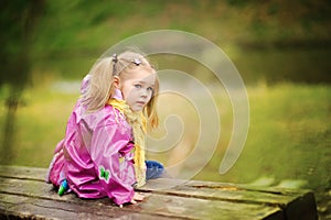 Smiling little girl at rainy day in the park