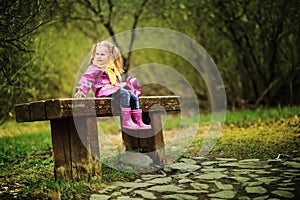 Smiling little girl at rainy day in the park