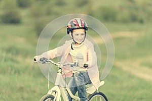 Smiling little girl riding a bike