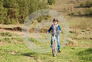 Smiling little girl riding a bike