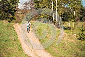 Smiling little girl riding a bike