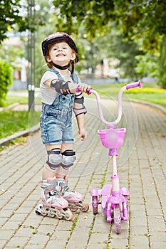 Smiling little girl in roller and protective