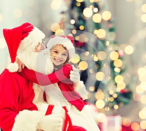 Smiling little girl with santa claus