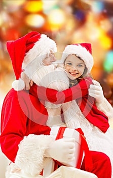 Smiling little girl with santa claus