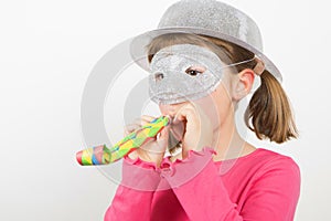 Smiling little girl with silver mask and silver hat isolated on white background photo