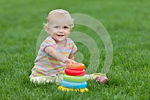 Smiling little girl with a toy pyramid