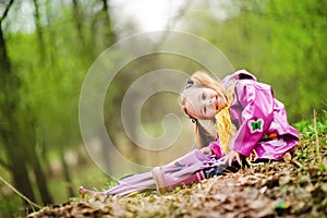 Smiling little girl with umbrella in the park