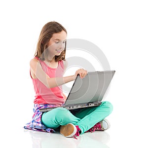 Smiling little girl using a laptop