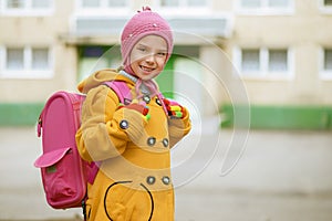 Smiling little girl in yellow coat