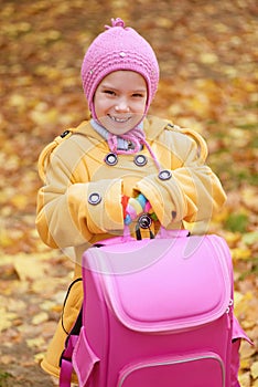 Smiling little girl in yellow coat