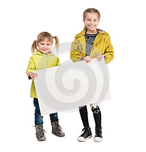 Smiling little girls with blank sheets in hands