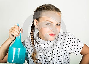 Smiling little housewife washed the window with a cloth and detergent. Large glass in foam. Housework concept.