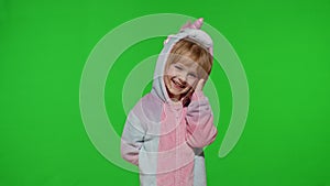 Little kid girl daughter in unicorn pajamas using speaking talking on mobile cell phone with mother
