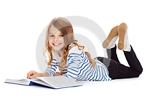 Smiling little student girl lying on the floor